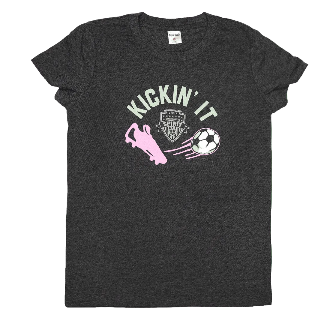 A dark heather gray short-sleeve t-shirt with a graphic on the front featuring the text 'KICKIN' IT' in light green, a pink cleat, and a soccer ball. The shirt is displayed flat against a solid white background.
