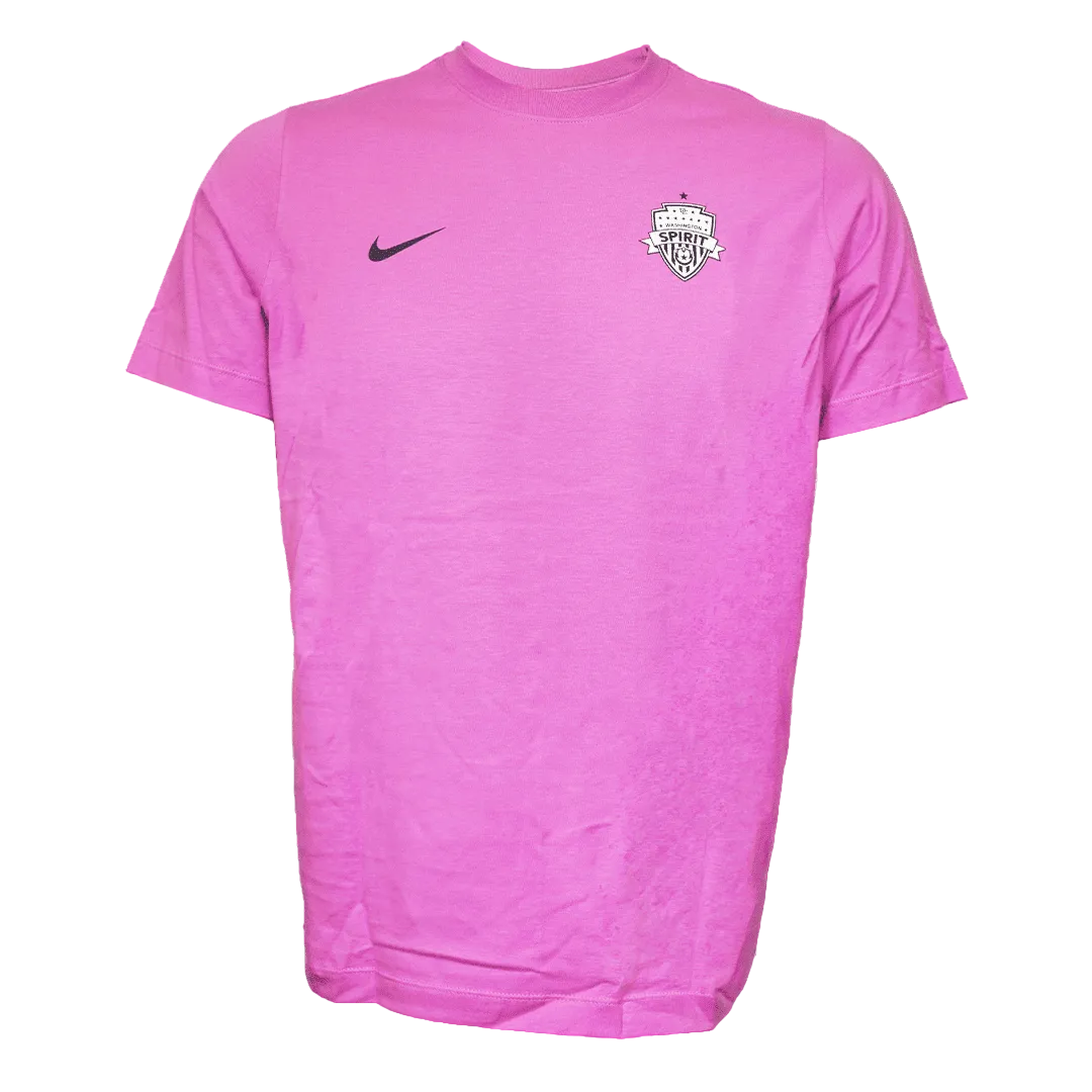 A pink short-sleeve Nike t-shirt featuring a black swoosh on the right chest and a white and black Washington Spirit crest on the left chest, displayed against a plain white background.