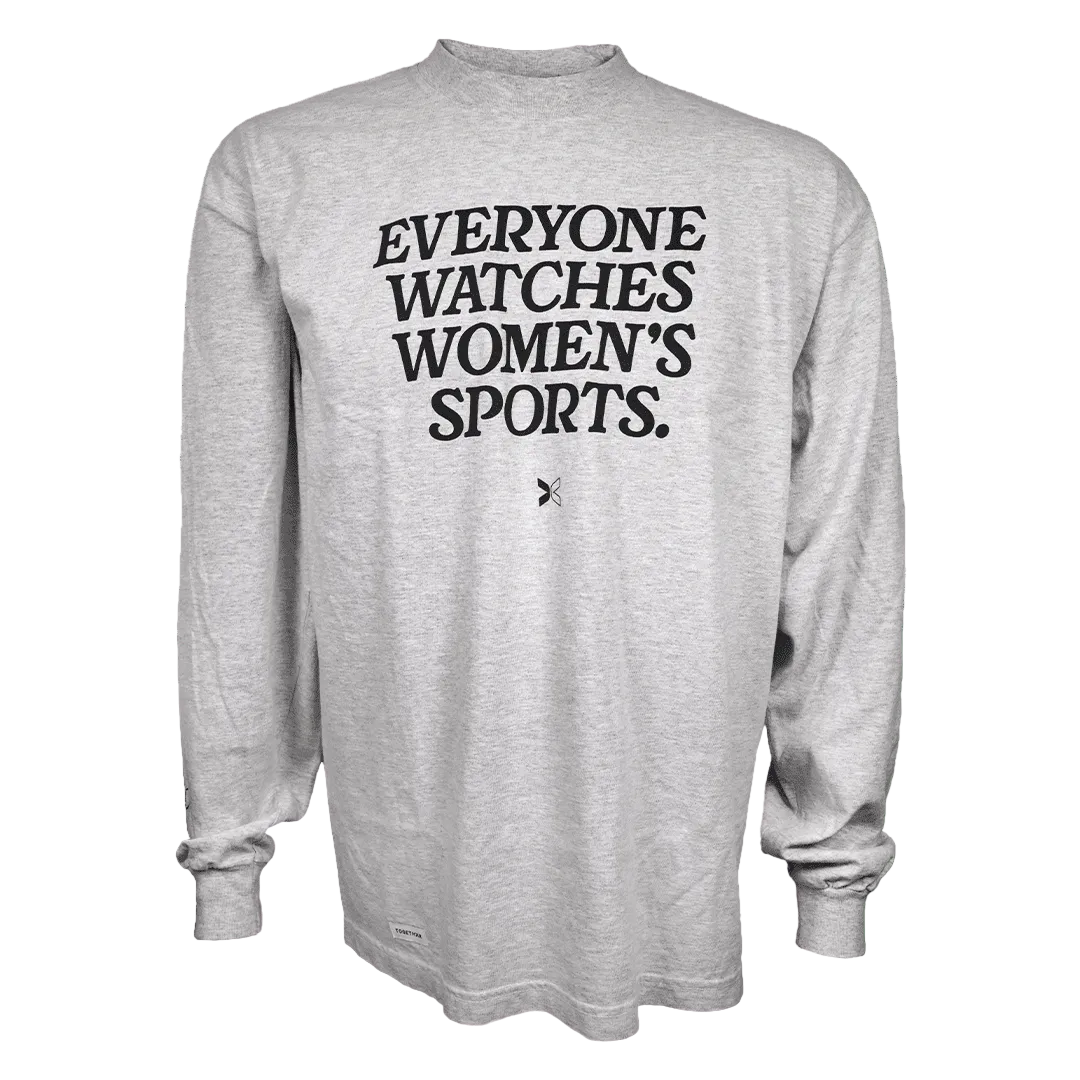 A light heather gray long-sleeve t-shirt with the text 'EVERYONE WATCHES WOMEN'S SPORTS.' printed in black across the chest, displayed on a solid white background.